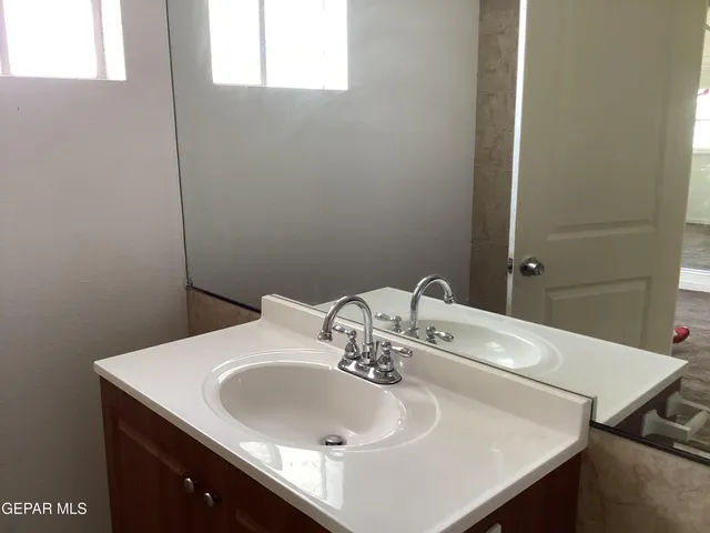 a bathroom with a sink and a mirror