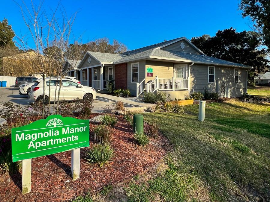 a view of a house with backyard and sitting area
