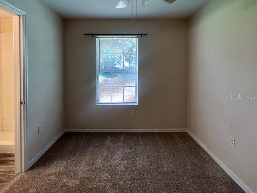 3911 Southwest 27th Street, Unit 8 Gainesville, FL 32608 - Photo 12 of 16 an empty room with a window