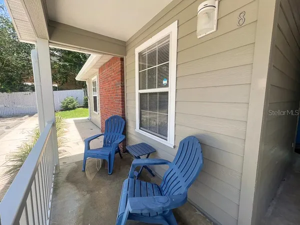 a view of a chair and table in the balcony