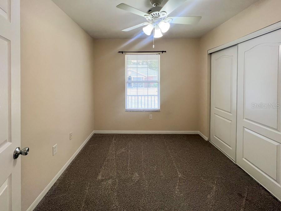 3911 Southwest 27th Street, Unit 8 Gainesville, FL 32608 - Photo 4 of 16 an empty room with a window and a fan