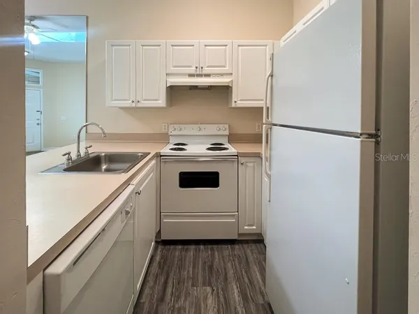 a kitchen with a sink a stove and refrigerator
