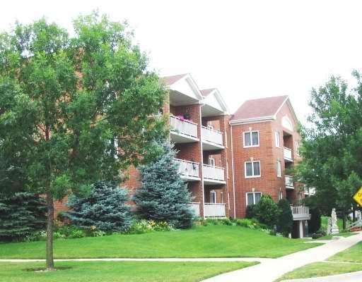 a front view of a building and trees