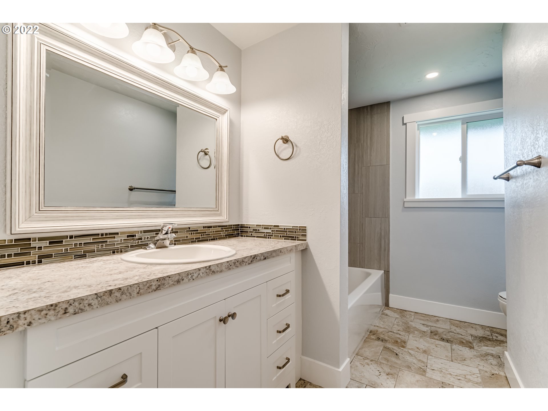 423 F Street Springfield, OR 97477 - Photo 17 of 29 a bathroom with a granite countertop sink and a mirror