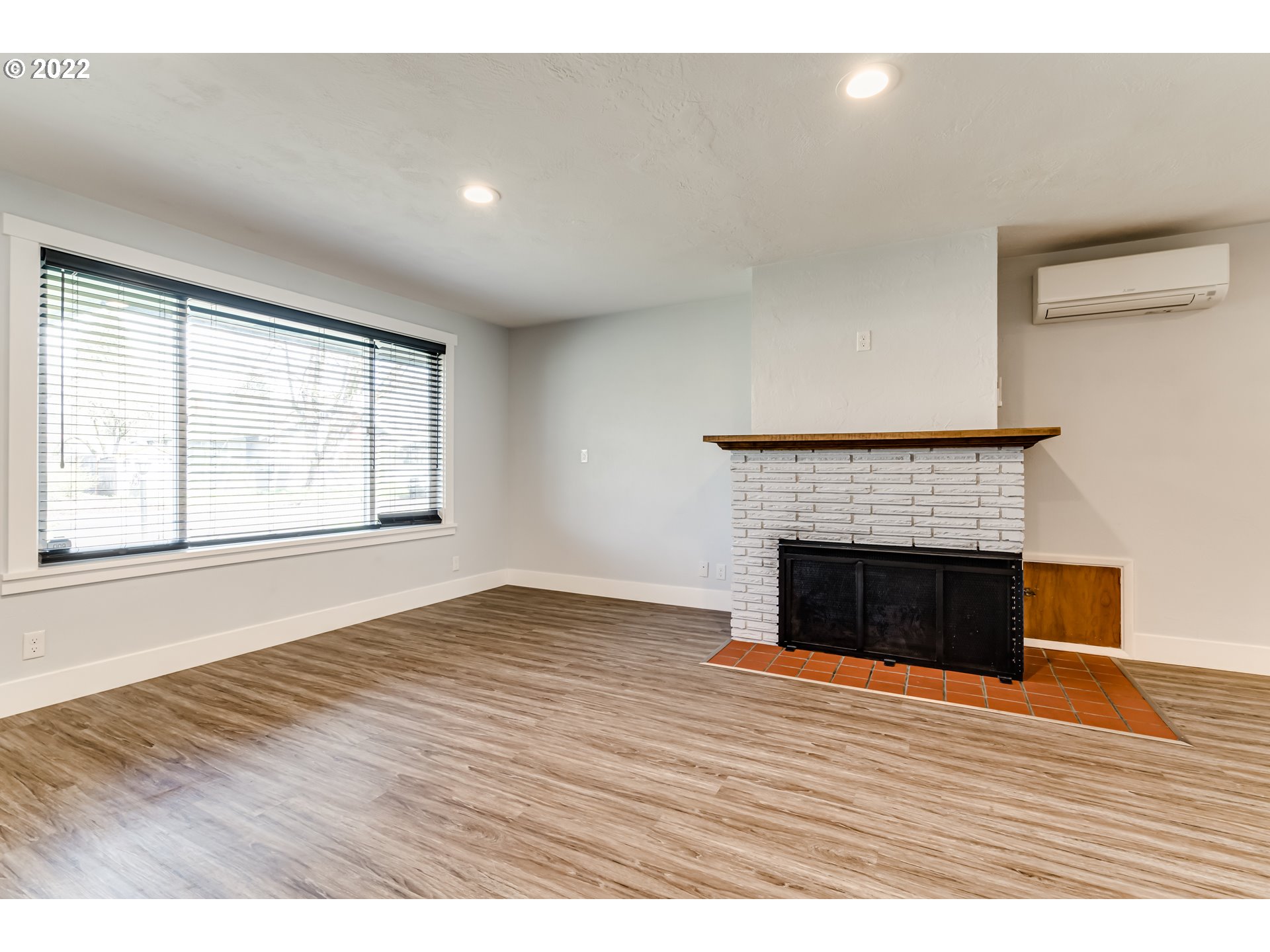 423 F Street Springfield, OR 97477 - Photo 2 of 29 a view of empty room with wooden floor and fireplace