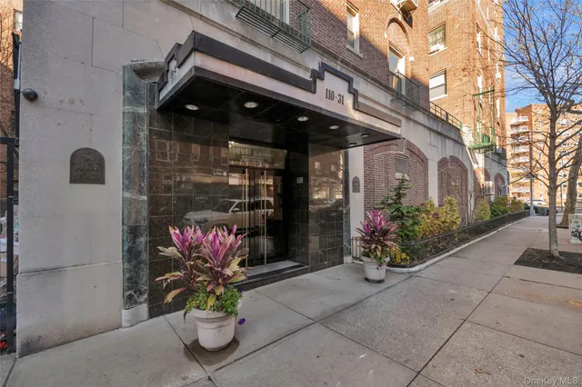 a front view of a house with sitting area