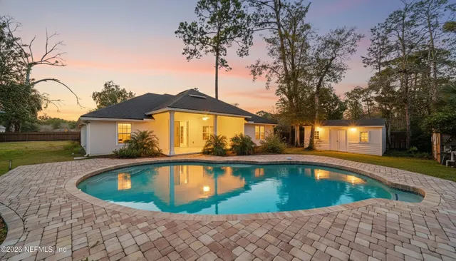 a view of a swimming pool with a yard
