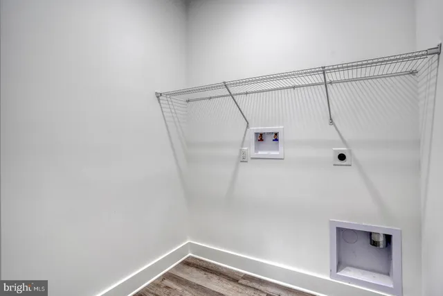 a view of walk in closet with clothes