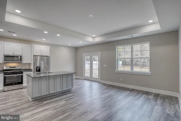 a kitchen with stainless steel appliances a refrigerator and a stove top oven