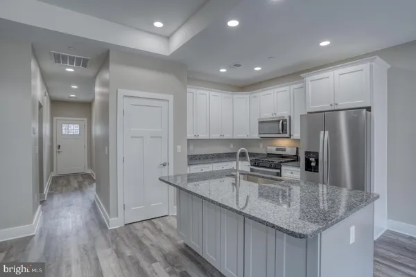 a kitchen with refrigerator and cabinets