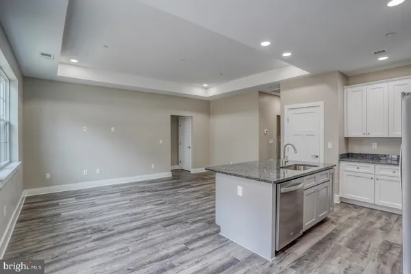 a kitchen with stainless steel appliances granite countertop a stove and a refrigerator