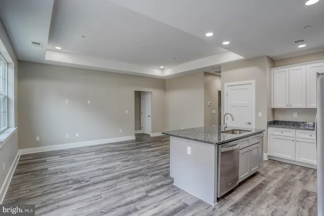 a kitchen with stainless steel appliances granite countertop a stove and a refrigerator