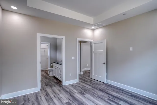 a view of a room with wooden floor