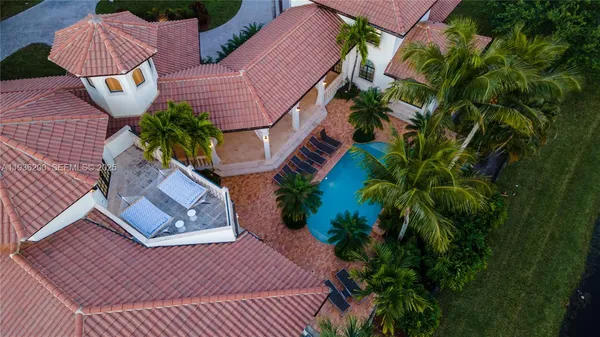a swimming pool with outdoor seating and yard