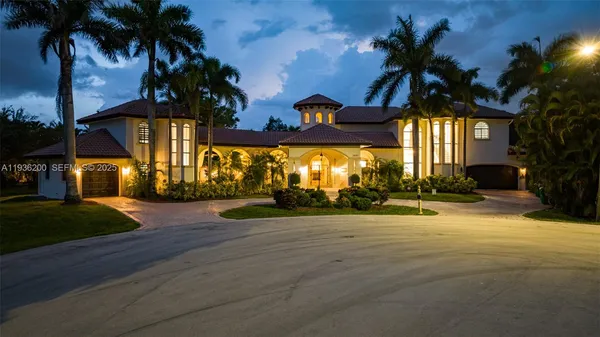 a view of a house with a yard and tree s