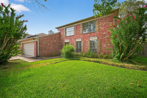a front view of house with yard and green space