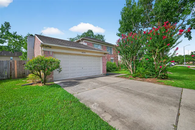 a front view of a house with a yard and a garage