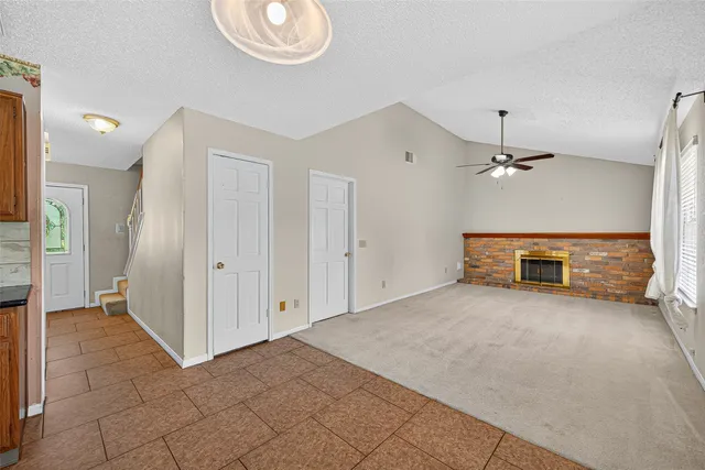 a kitchen with granite countertop cabinets and refrigerator