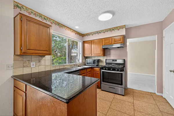 a kitchen with stainless steel appliances a stove sink and cabinets