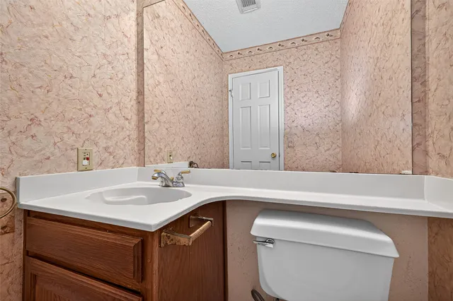 an empty room with a window and a ceiling fan