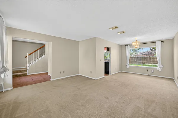 a view of an empty room with closet and wooden floor