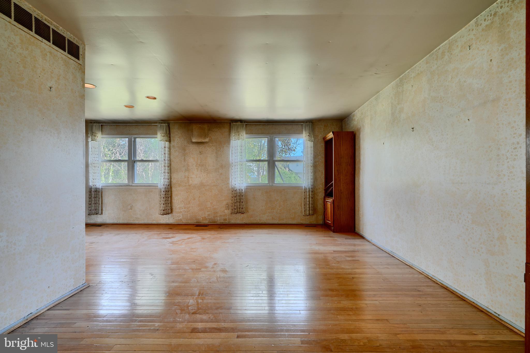 3902 Winlee Road Randallstown, MD 21133 - Photo 15 of 44 a view of an empty room with a window and wooden floor