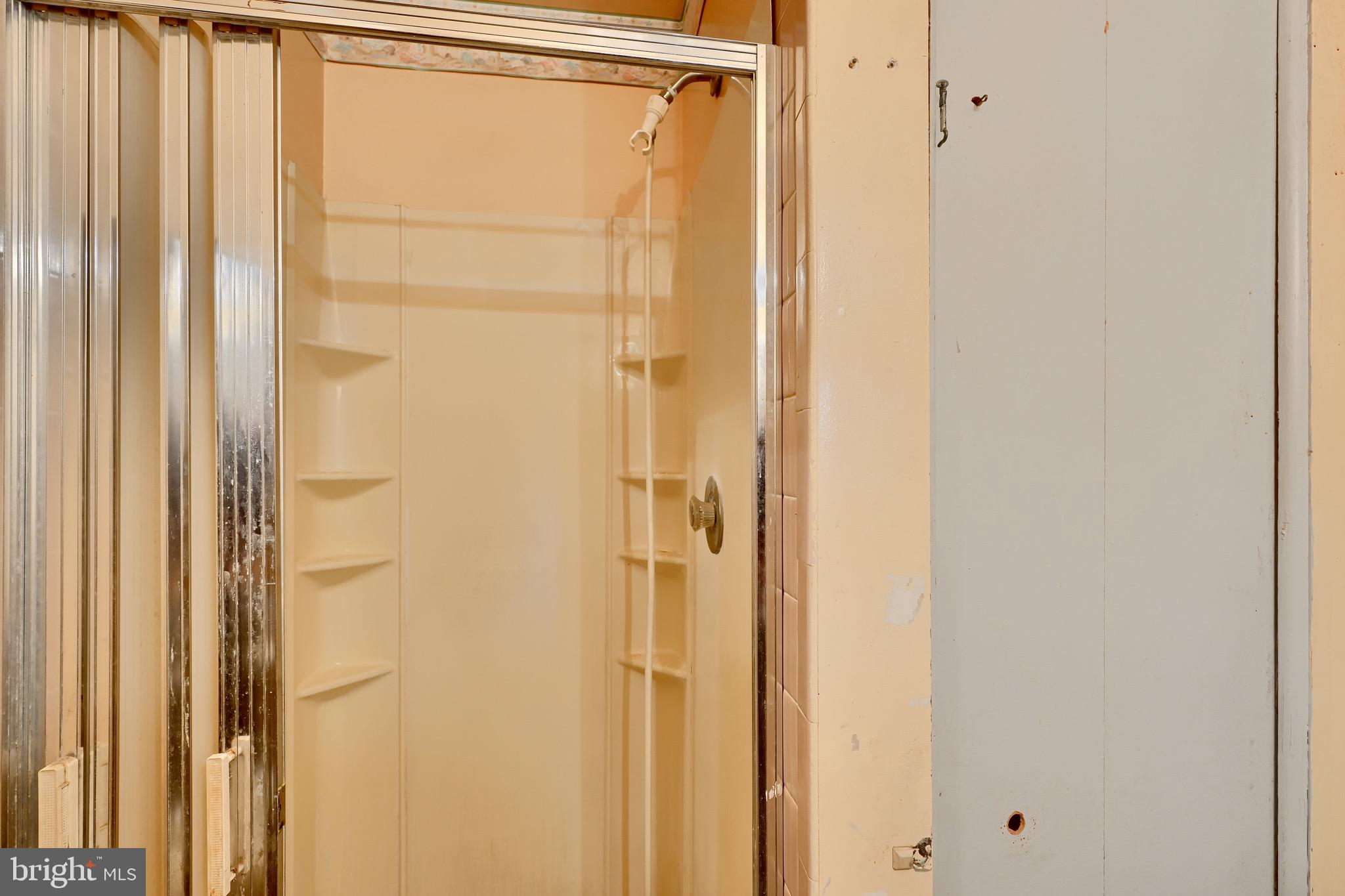 3902 Winlee Road Randallstown, MD 21133 - Photo 29 of 44 a bathroom with a glass shower door