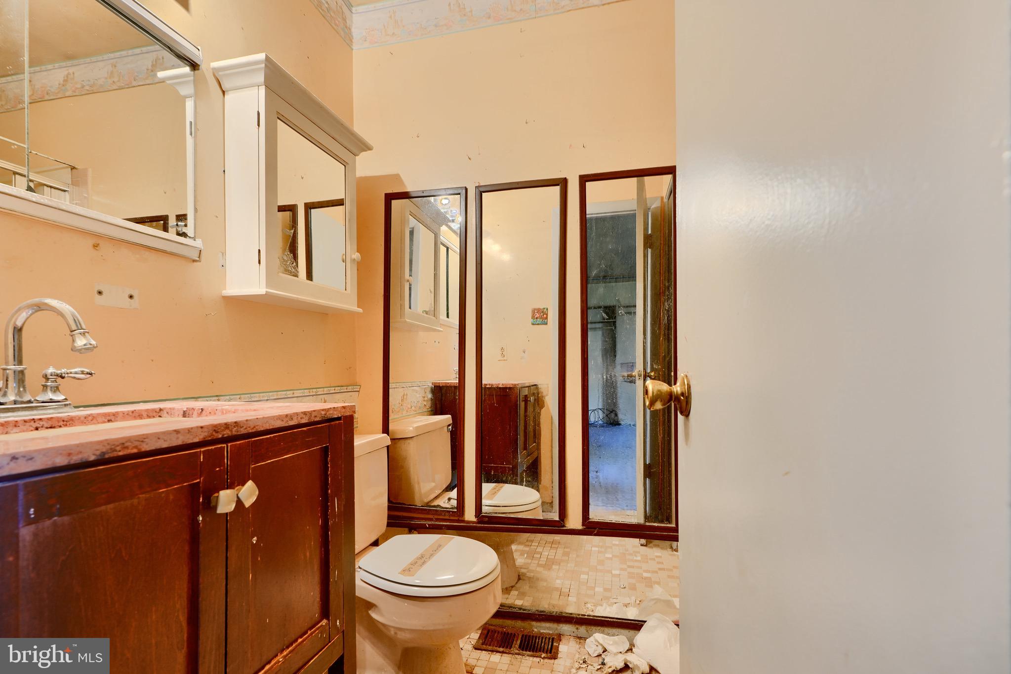 3902 Winlee Road Randallstown, MD 21133 - Photo 30 of 44 a bathroom with a granite countertop toilet sink and mirror
