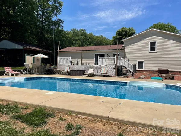 a view of a house with pool porch and furniture
