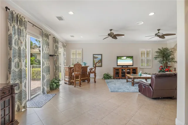 a living room with furniture large window and flat screen tv