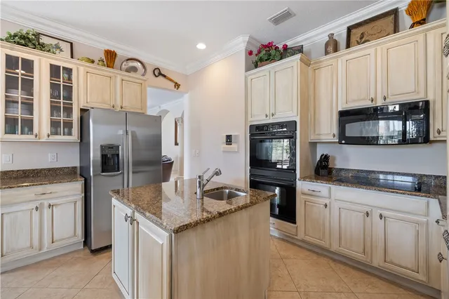 a kitchen with stainless steel appliances granite countertop a refrigerator stove and sink