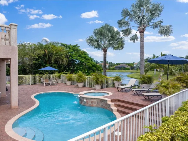 a view of a swimming pool with a patio and a garden