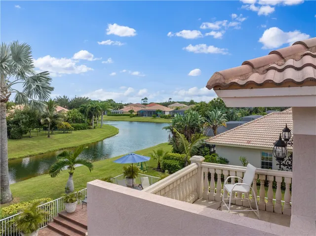 a view of a house with pool and a yard