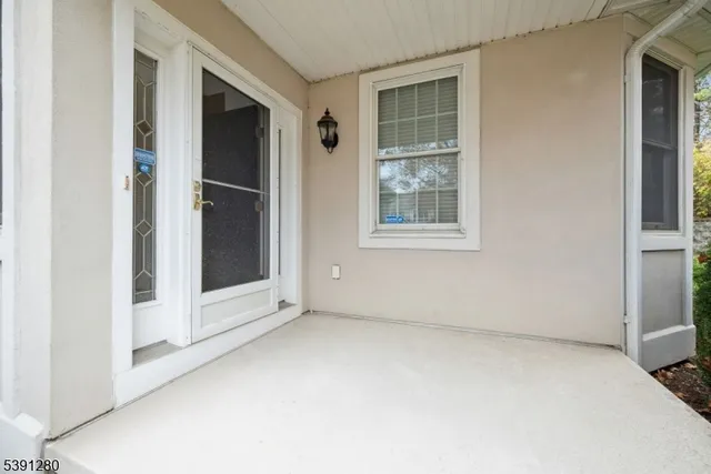 an empty room with windows and entrance