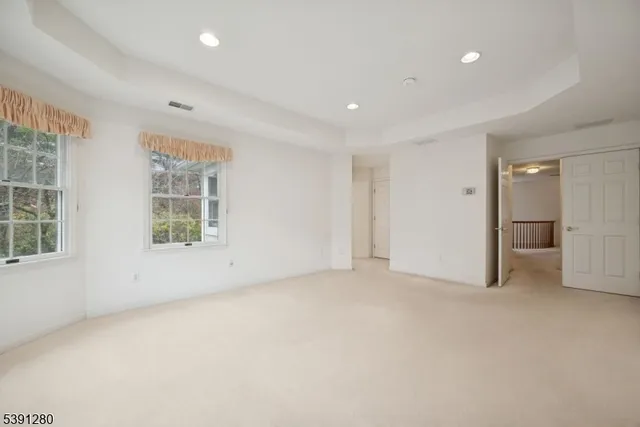 an empty room with windows and closet