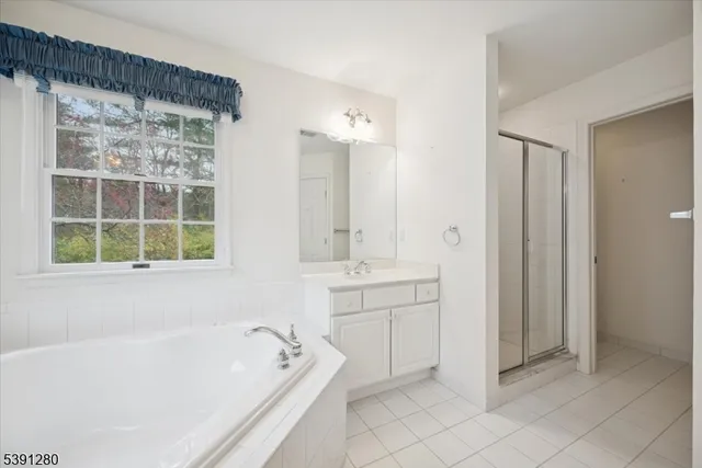 a bathroom with a bathtub sink and mirror