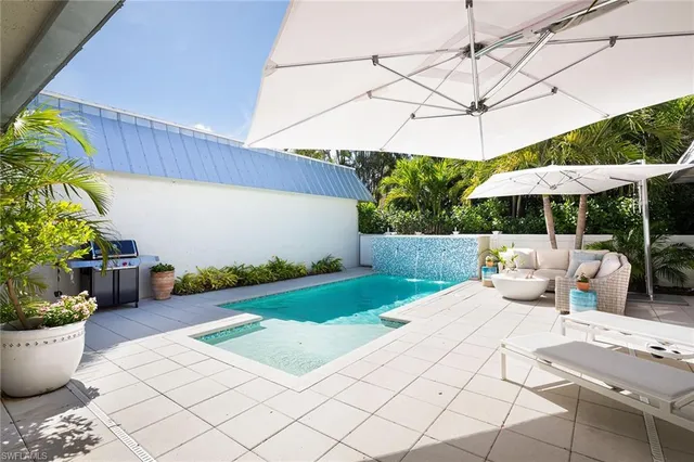 a view of a patio with plants and chairs