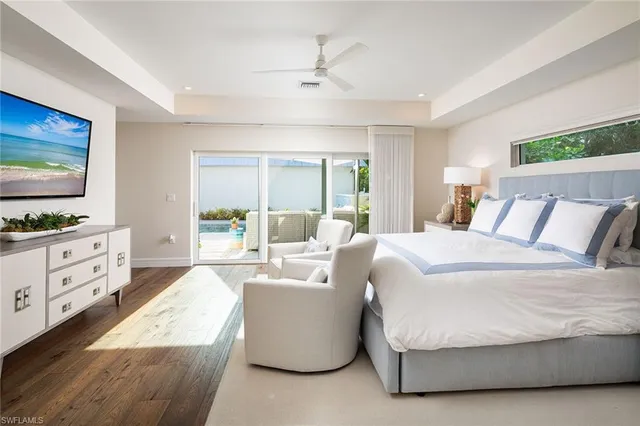 a spacious bedroom with a large bed and a flat screen tv