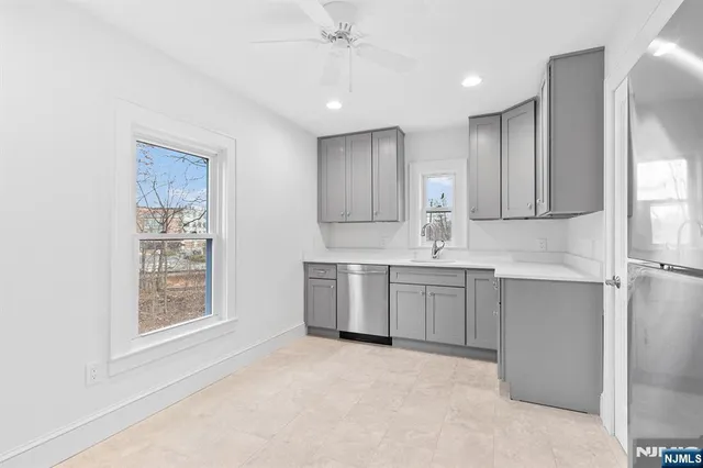 a kitchen with a sink cabinets and window