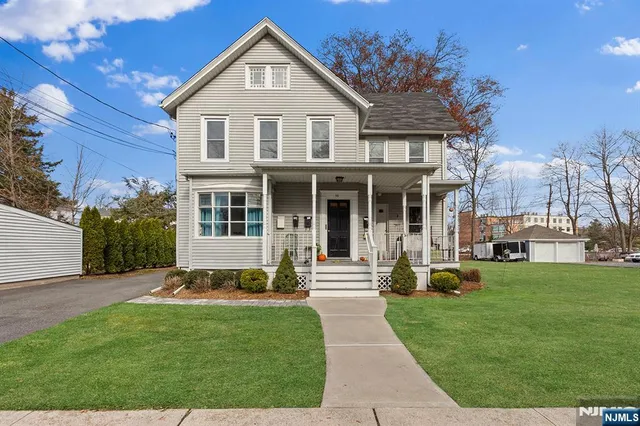 a front view of a house with a garden and yard