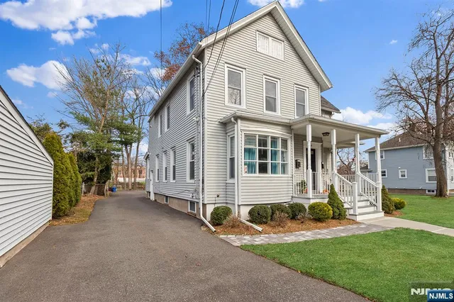a front view of a house with a yard and porch