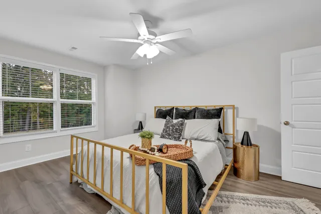 a bed sitting in a bedroom next to a window