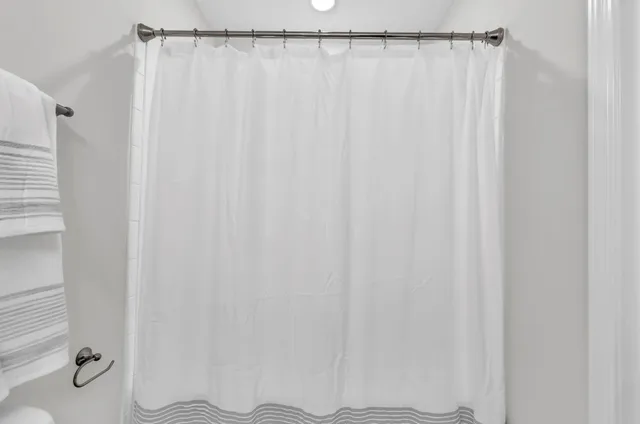 a bathroom with a shower curtain and toilet