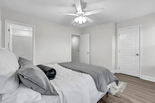 a bedroom with a bed and a chandelier