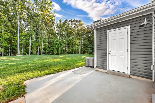 a view of a house with a yard and garage