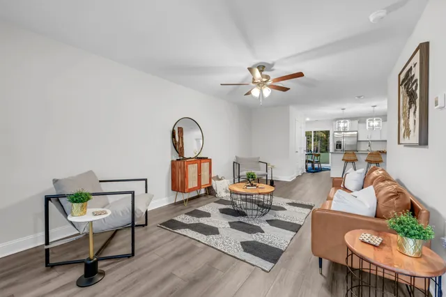 a living room with furniture a rug and a chandelier