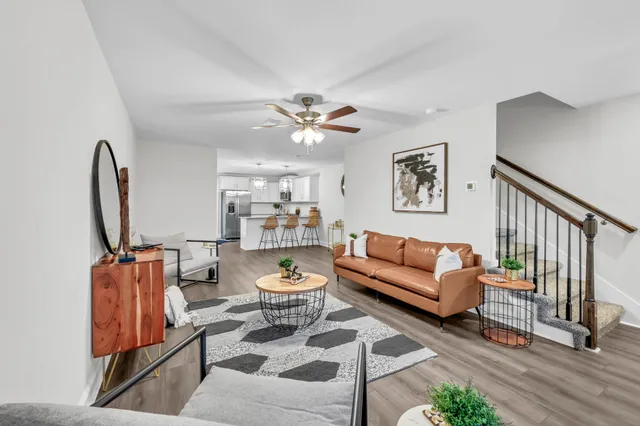 a living room with furniture a rug and a chandelier