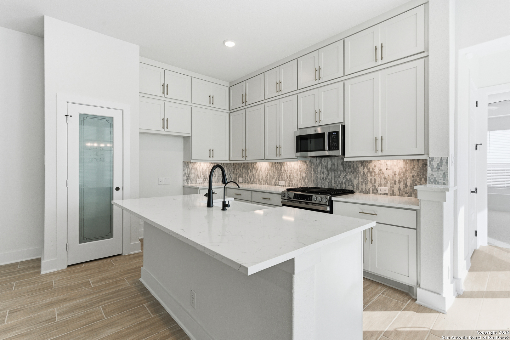20675 Huebner Road, Unit 527 San Antonio, TX 78258 - Photo 13 of 43 a kitchen with stainless steel appliances a stove a sink and a refrigerator