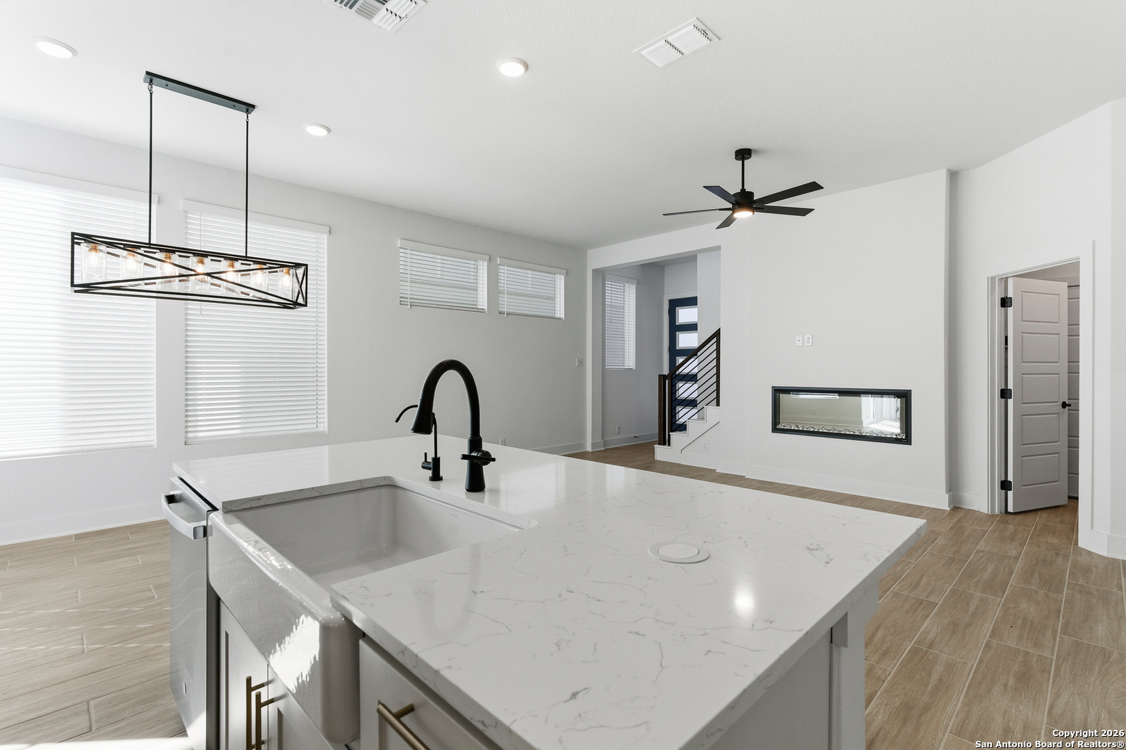 20675 Huebner Road, Unit 527 San Antonio, TX 78258 - Photo 16 of 43 a view of a kitchen island a sink and wooden floor