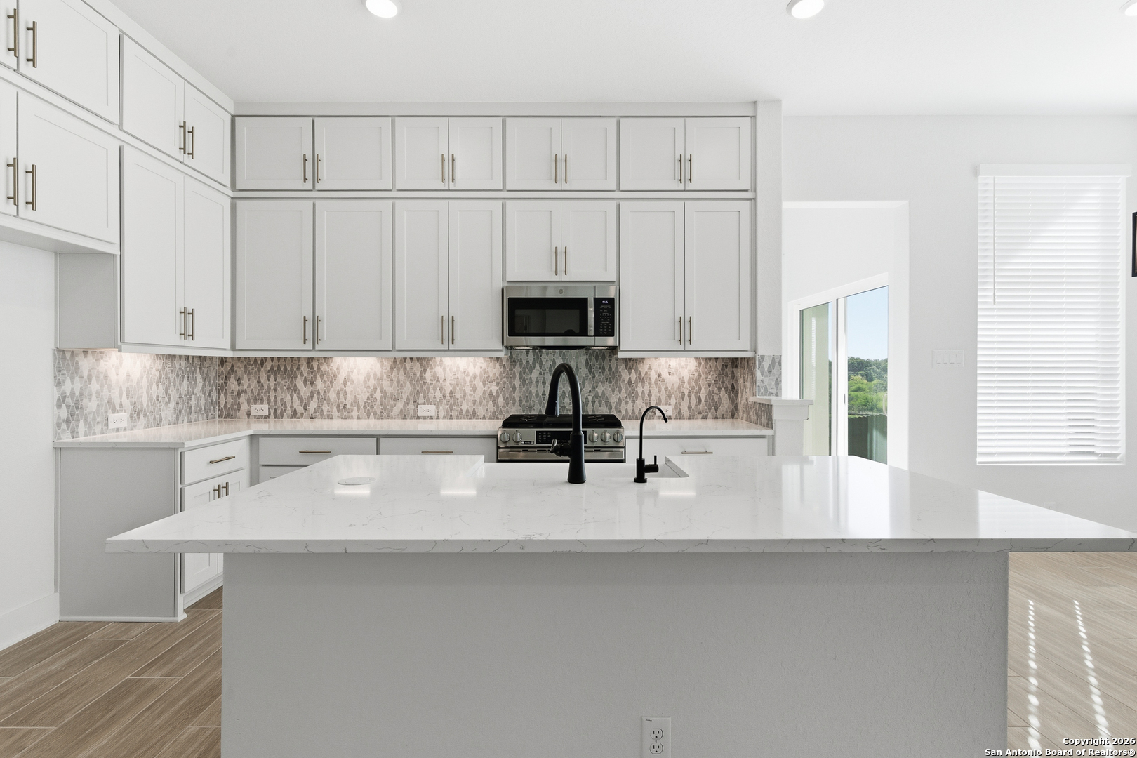 20675 Huebner Road, Unit 527 San Antonio, TX 78258 - Photo 17 of 43 a kitchen with a white cabinets and a sink